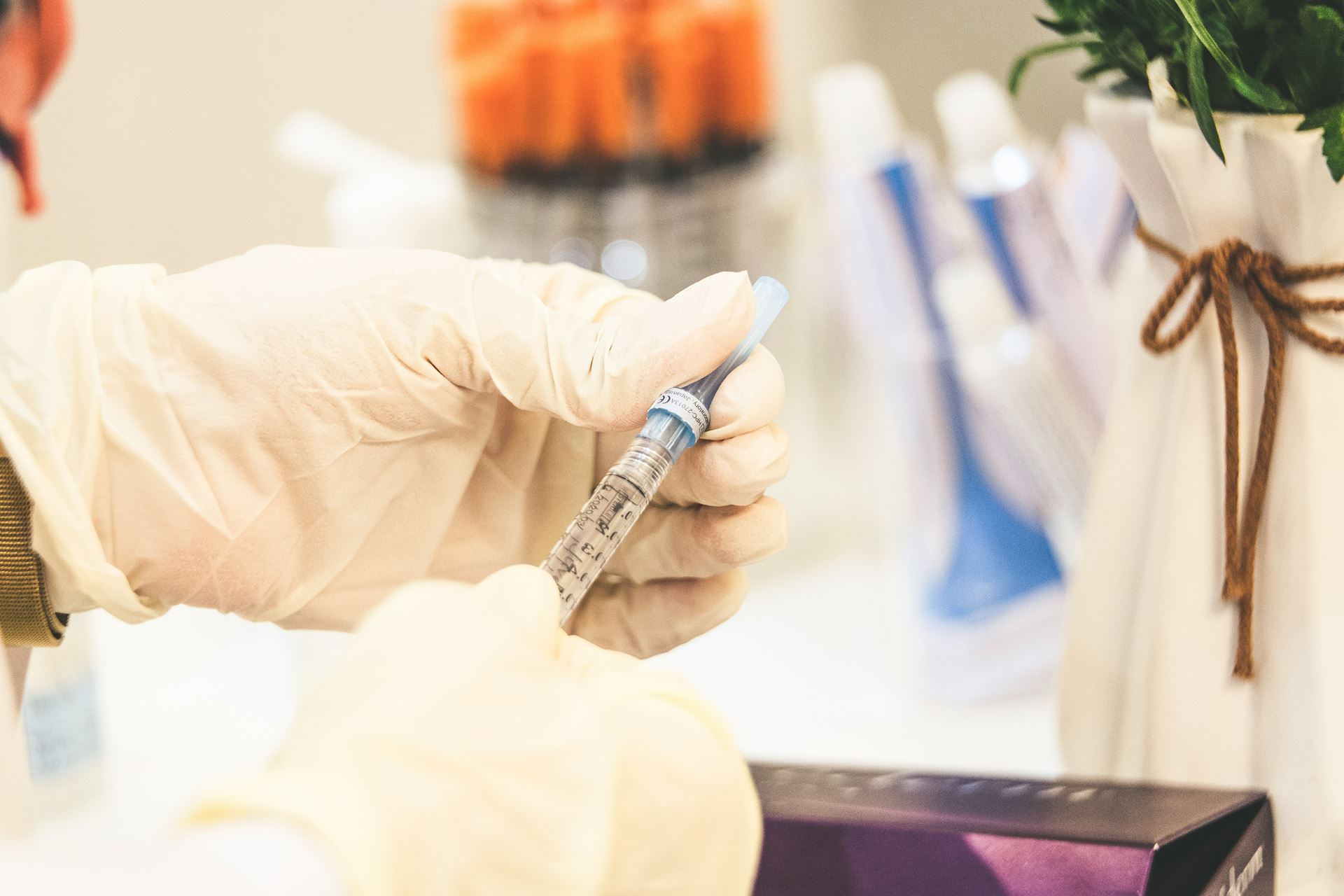 Photo of a hand holding a syringe